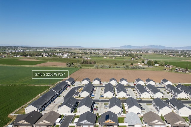 aerial view of property's location with nearby suburban area and a mountainous background