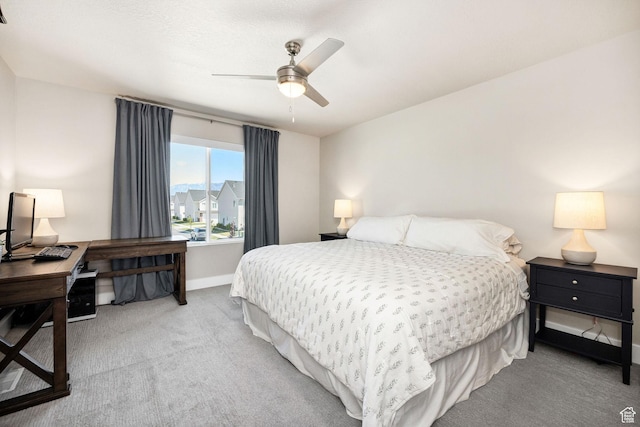 bedroom with carpet flooring, an office area, baseboards, and ceiling fan