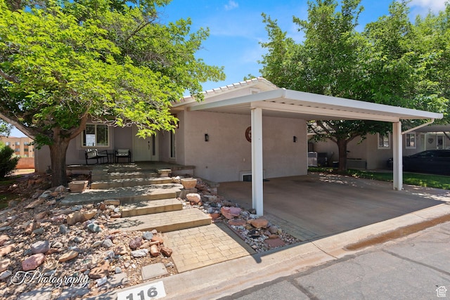 180 N 1100 E Unit 116, Washington, UT 84780 - view of front of property featuring stucco siding, a carport, and a tiled roof