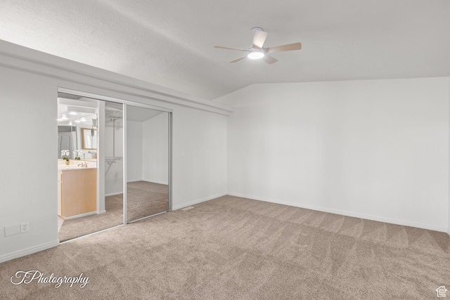 180 N 1100 E Unit 116, Washington, UT 84780 - unfurnished bedroom with carpet floors, lofted ceiling, a closet, baseboards, and a ceiling fan
