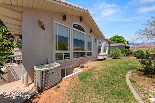 180 N 1100 E Unit 116, Washington, UT 84780 - view of side of home featuring central air condition unit, a yard, and stucco siding