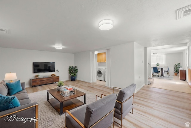 180 N 1100 E Unit 116, Washington, UT 84780 - living room with light wood-style floors, washer / dryer, and baseboards