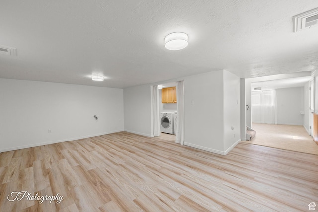 180 N 1100 E Unit 116, Washington, UT 84780 - finished below grade area with washer / dryer, light wood-type flooring, baseboards, and a textured ceiling