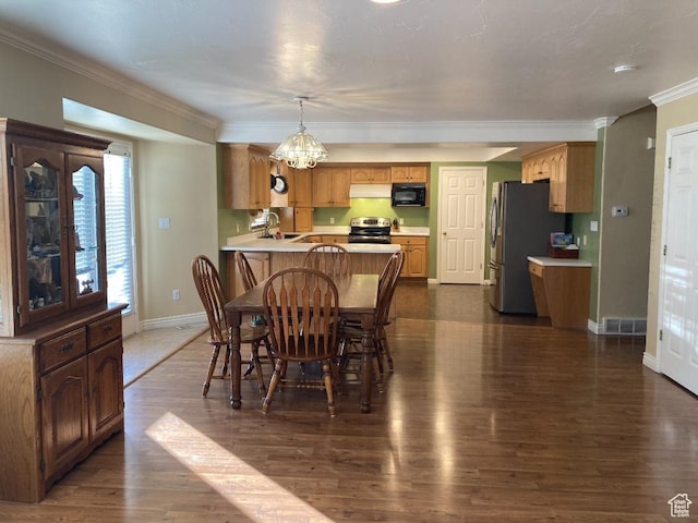 dining room with baseboards, dark wood-style flooring, crown molding, and a chandelier