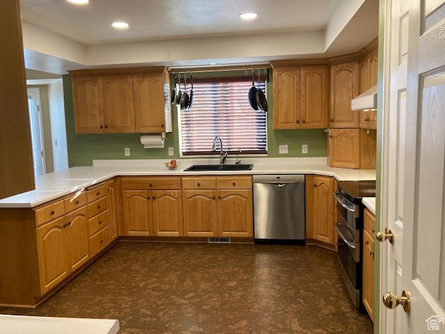 kitchen featuring stainless steel appliances, a sink, light countertops, a peninsula, and recessed lighting
