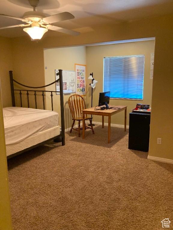 bedroom featuring carpet floors, a desk, a ceiling fan, and baseboards