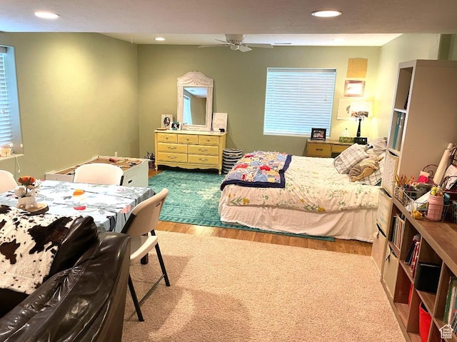bedroom featuring wood finished floors, recessed lighting, and multiple windows