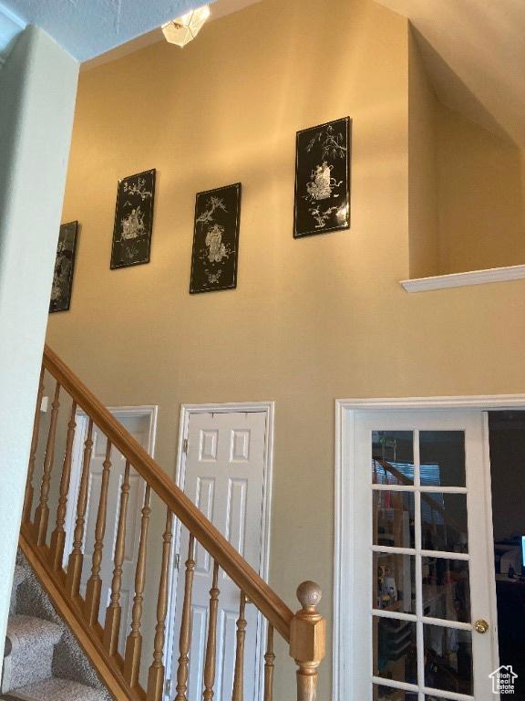 staircase with a towering ceiling