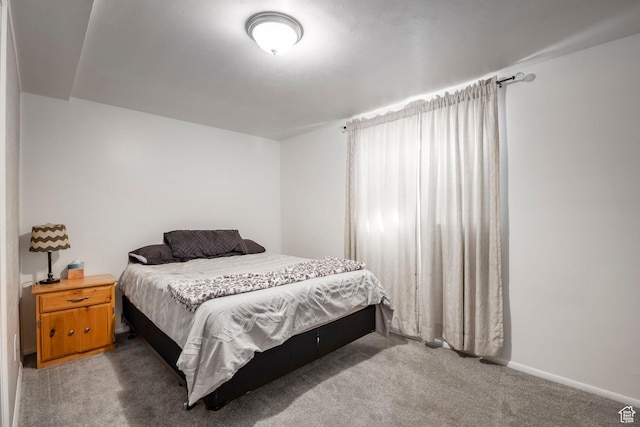 carpeted bedroom featuring baseboards