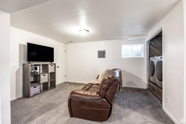 living room with washing machine and dryer, carpet flooring, and baseboards