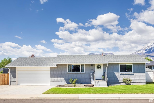 single story home featuring a garage, concrete driveway, and brick siding