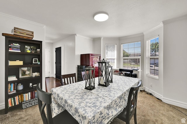 dining area featuring ornamental molding, baseboards, and carpet