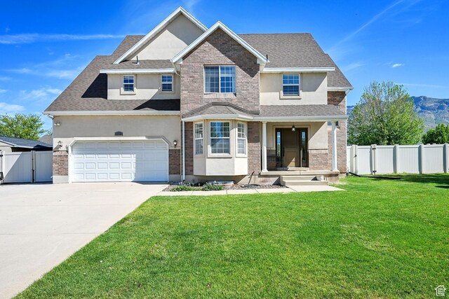 view of front of property with stucco siding, a gate, concrete driveway, a garage, and roof with shingles
