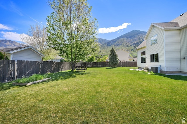view of yard with a mountain view and central AC