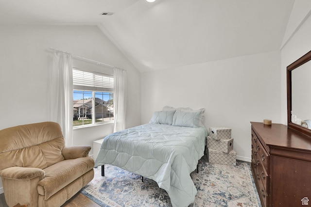 bedroom featuring vaulted ceiling and baseboards