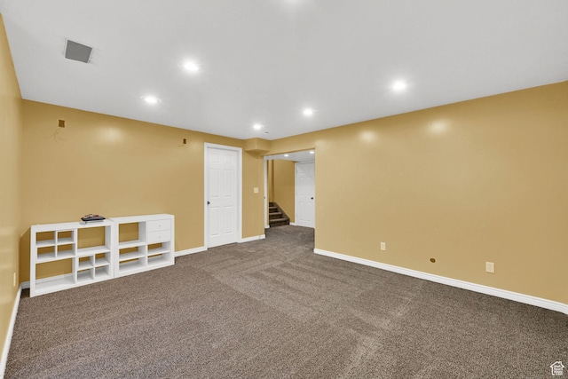 unfurnished room featuring dark colored carpet, stairs, baseboards, and recessed lighting