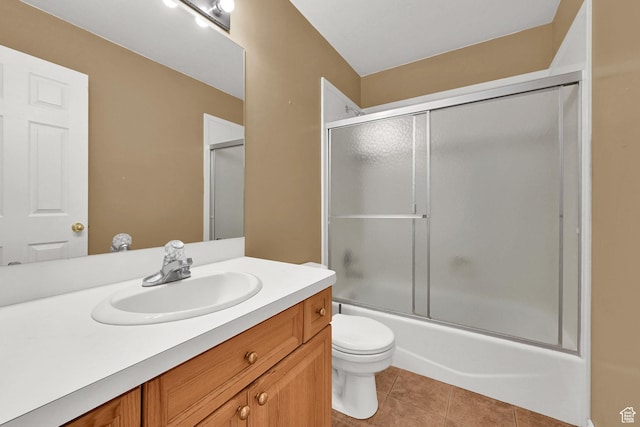 bathroom with vanity, toilet, tile patterned floors, and combined bath / shower with glass door