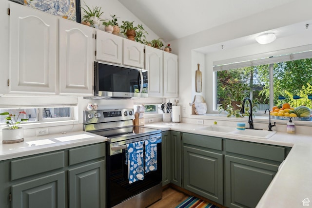 1298 E 5875 S, Ogden, UT 84405 - kitchen featuring appliances with stainless steel finishes, a sink, green cabinets, light countertops, and lofted ceiling