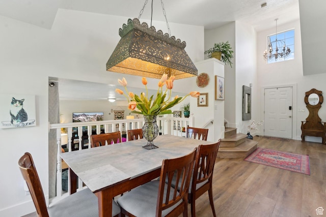 1298 E 5875 S, Ogden, UT 84405 - dining space featuring a chandelier, wood finished floors, and a towering ceiling