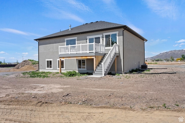3287 S 4950 W, West Haven, UT 84401 - back of house with stairway, a deck with mountain view, cooling unit, and stucco siding