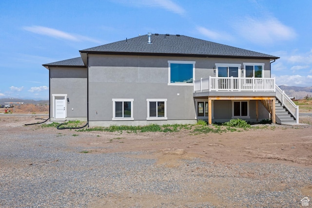 3287 S 4950 W, West Haven, UT 84401 - rear view of house with a wooden deck, stairway, and stucco siding