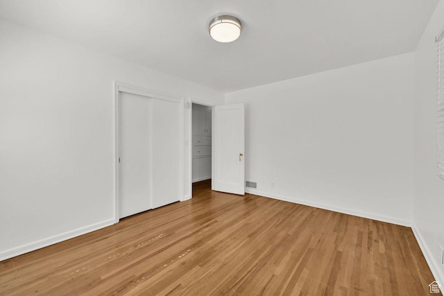 1375 E 3100th St S, Ogden, UT 84403 - unfurnished bedroom with light wood-style flooring, a closet, and baseboards