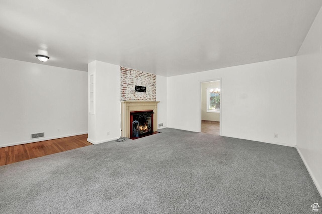 1375 E 3100th St S, Ogden, UT 84403 - unfurnished living room with carpet floors, a fireplace with flush hearth, and baseboards