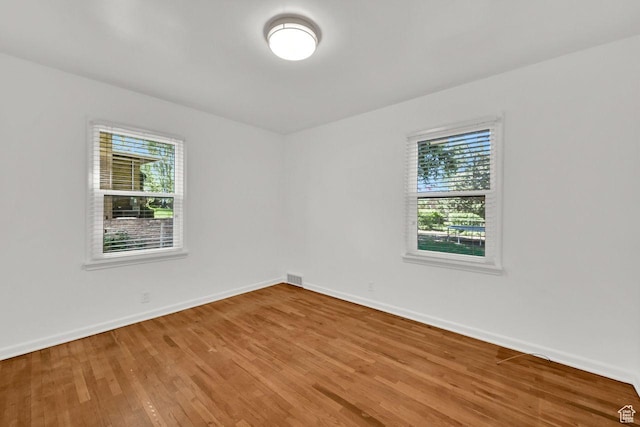 1375 E 3100th St S, Ogden, UT 84403 - unfurnished room featuring healthy amount of natural light, wood finished floors, and baseboards