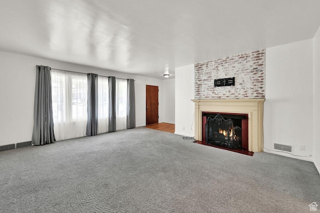 1375 E 3100th St S, Ogden, UT 84403 - unfurnished living room featuring carpet flooring and a fireplace with flush hearth