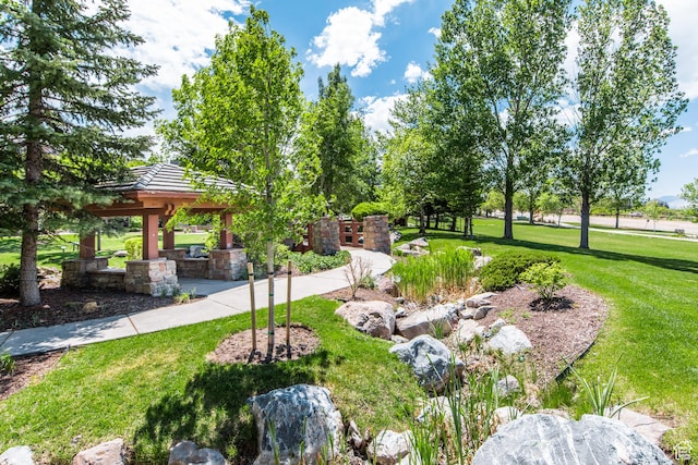 surrounding community with a gazebo and a lawn
