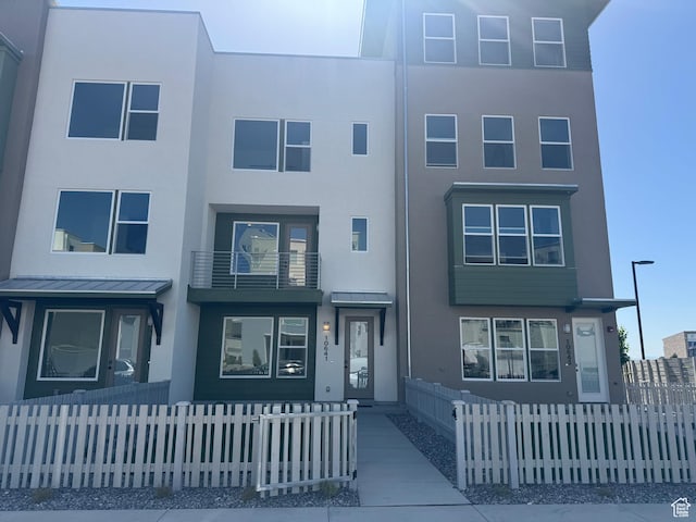 multi unit property featuring stucco siding and a standing seam roof