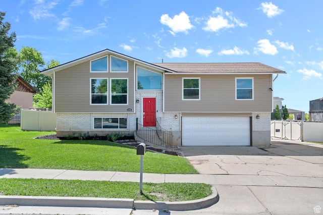 1188 E 300 N, Layton, UT 84040 - raised ranch with an attached garage, brick siding, and driveway
