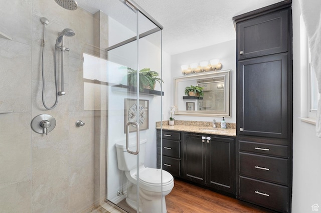1188 E 300 N, Layton, UT 84040 - full bathroom with a stall shower, wood finished floors, vanity, toilet, and a textured ceiling