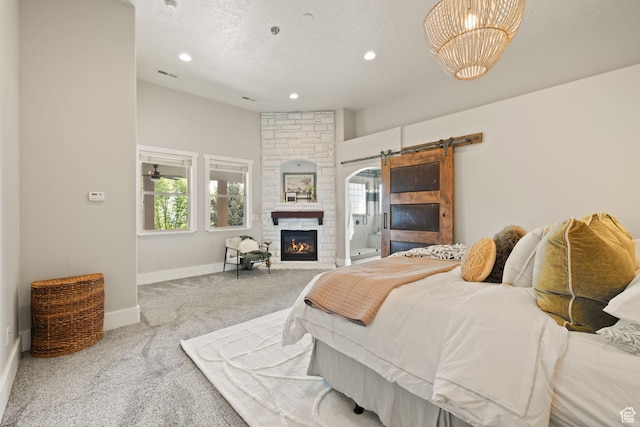 bedroom with carpet, baseboards, multiple windows, recessed lighting, and a barn door