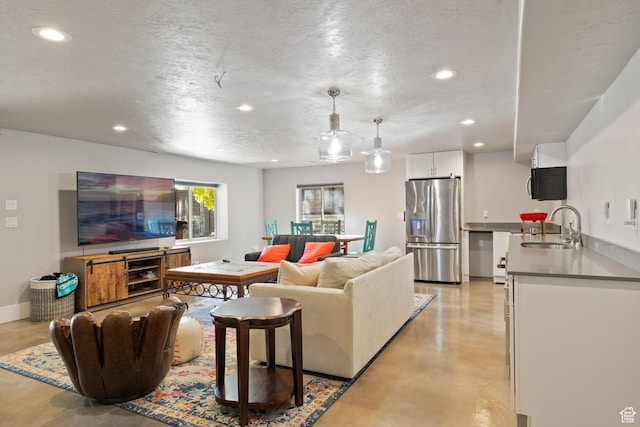 living room with recessed lighting, concrete flooring, and a textured ceiling
