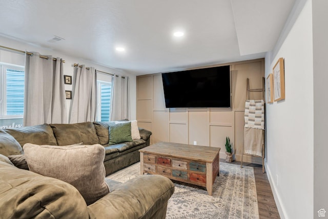 living room with wood finished floors, baseboards, and recessed lighting