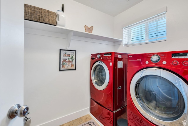 laundry area with washer and clothes dryer, baseboards, and tile patterned flooring