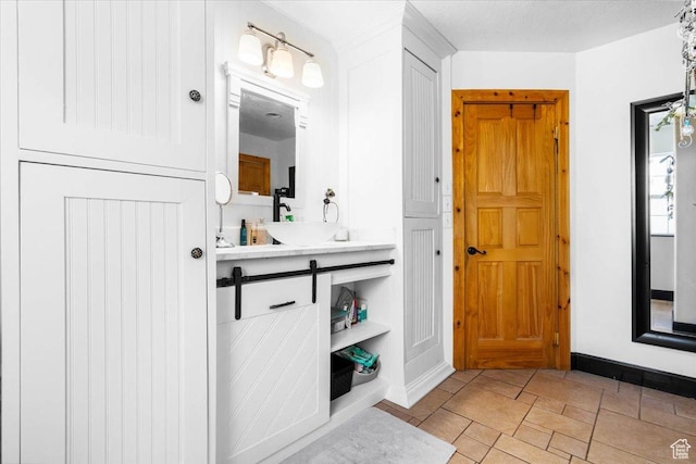bathroom featuring baseboards and vanity