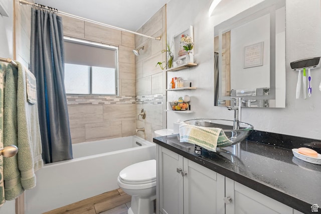 bathroom featuring shower / tub combo, toilet, vanity, and wood finished floors
