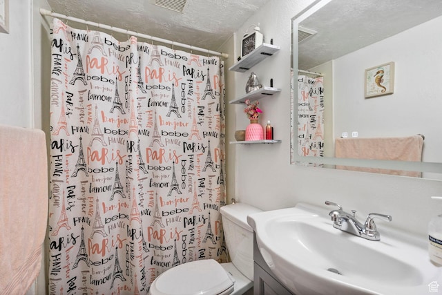 full bathroom featuring a textured ceiling, toilet, vanity, and a shower with shower curtain