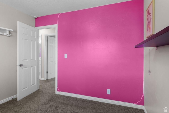 empty room with carpet flooring and baseboards