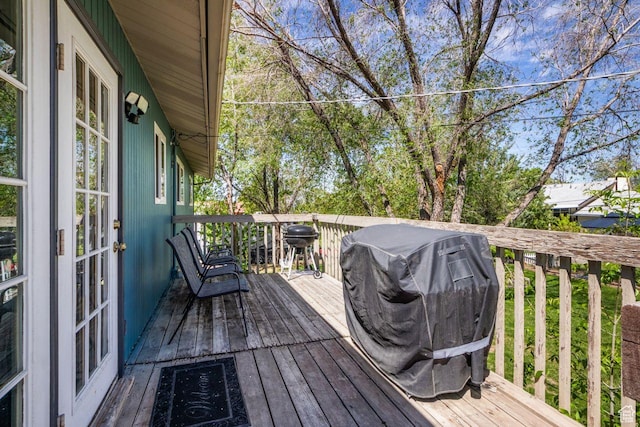wooden terrace featuring area for grilling and french doors