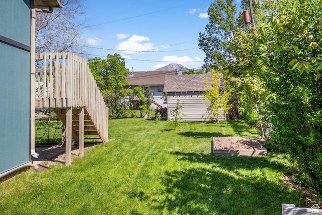 view of grassy yard with stairway