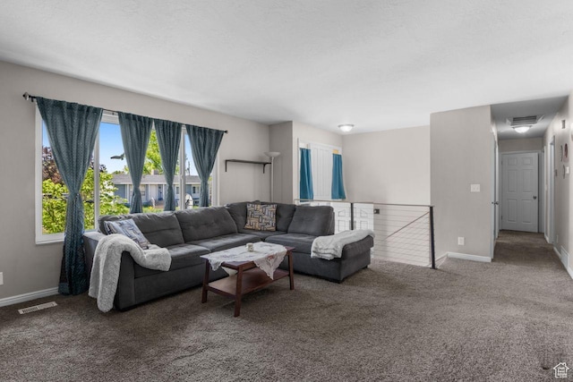 carpeted living area with baseboards