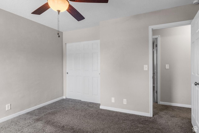 unfurnished bedroom featuring carpet floors, baseboards, and ceiling fan
