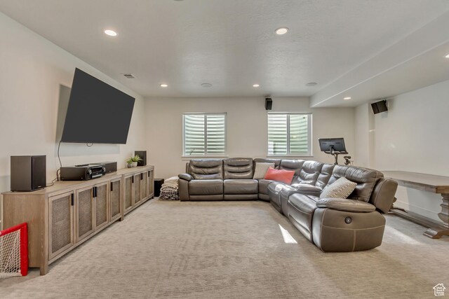 living area featuring recessed lighting, light carpet, and baseboards