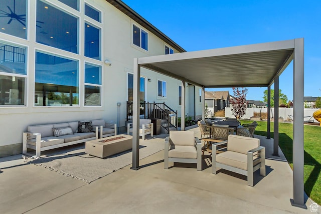 view of patio with an outdoor living space with a fire pit