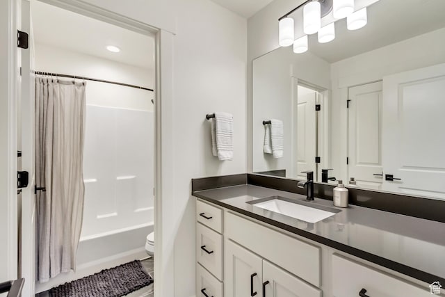 full bathroom featuring toilet, vanity, and shower / bathtub combination with curtain