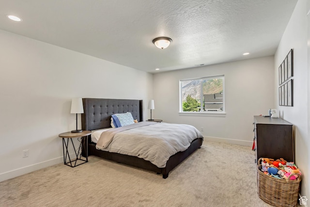 carpeted bedroom featuring baseboards and recessed lighting