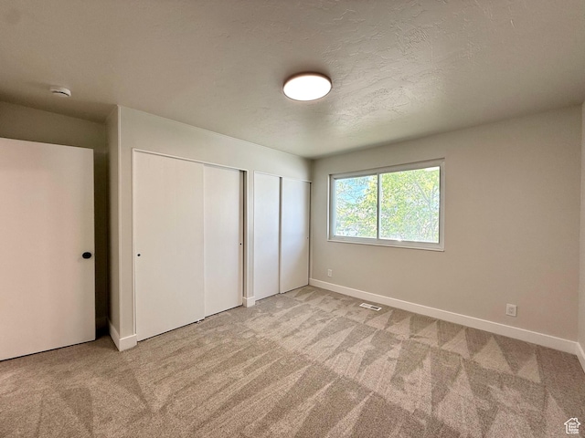 445 Havasu, Tooele, UT 84074 - unfurnished bedroom featuring multiple closets, carpet floors, and baseboards